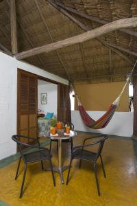 a room with a table and two chairs and a hammock at Hotel Cinaruco Caney in Villavicencio