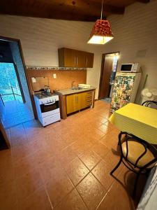 a kitchen with a table and a stove top oven at La Posada De Gogg Apartamentos in Bella Vista