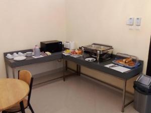 a small kitchen with a counter with a breakfast buffet at Djibguesthouse in Djibouti