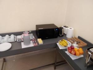 a counter with bowls of fruit on a table at Djibguesthouse in Djibouti