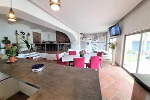 a living room with a table and red chairs at VILLA avec piscine - 4 chambres - parking - calme in Les Arcs sur Argens