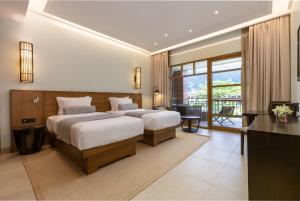 Voodi või voodid majutusasutuse Savoy Seychelles Resort & Spa toas