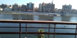 uma varanda com vista para o rio em اطلاله مباشره عالنيل em Kafr Abū Dabbūs