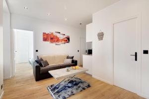 salon z kanapą i stołem w obiekcie Appartement - Stade de France w mieście Saint-Denis