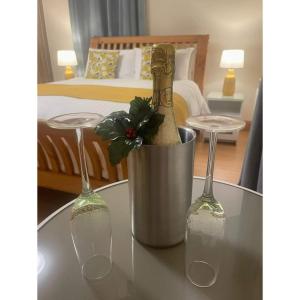 two wine bottles on a table with two glasses at Woodview Bed & Breakfast in Kilkeel