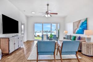 a living room with a couch and a tv at Indian Rocks Beach Hideaway in Clearwater Beach