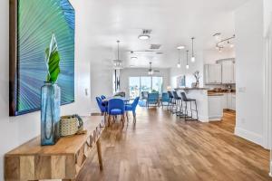 a living room with a table and blue chairs at Indian Rocks Beach Hideaway in Clearwater Beach