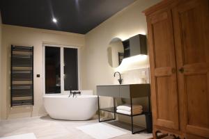 a bathroom with a large tub and a sink at Domaine de La Soudelle in Chanceaux-sur-Choisille +35 photos
