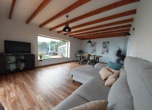 a living room with a couch and a table at Casa Percea in Mazo