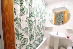 a bathroom with a sink and a shower curtain at 102 I Posada del Mar I Encantador hostel en la playa de Gandia in Los Mártires