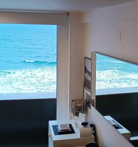 a room with a view of the ocean through a window at Apartamento Sisargas in Malpica