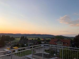 a view from the balcony of a house at sunset at Ferienwohnung Weserbergland Haus Nr 29 Erdgeschoss in Deensen