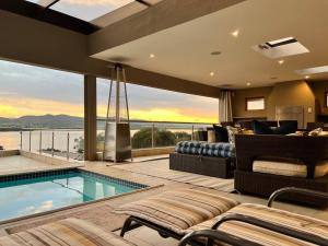 a house with a swimming pool and a living room at The Windsor- Hartbeespoort Dam in Hartbeespoort