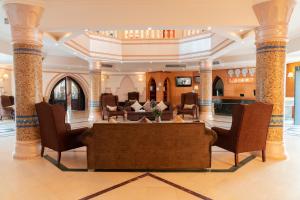 a lobby with chairs and a table in a building at Viva Sharm in Sharm El Sheikh