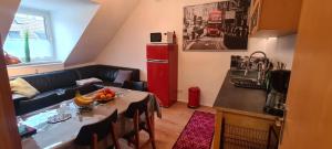 a small kitchen with a table and a red refrigerator at 3 Schlafzimmer &Wohnküche in Oberhausen
