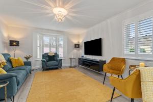 a living room with a couch and a tv at Cottage Mews - Seaside Cottage Parking Terrace in Tenby