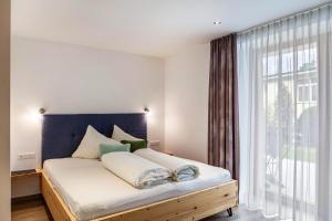 Łóżko lub łóżka w pokoju w obiekcie Apart-hochzillertal Gartenwohnung