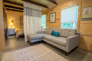 a living room with a couch and a bed at The Dailey Renewal Retreat B & B in Greensboro