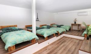 a bedroom with three beds in a room at Hostel Old Town in Bratislava