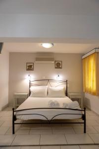 a bedroom with a large bed with white pillows at Studios Alsos in Naxos Chora