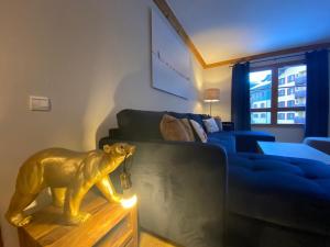 a living room with a lion statue on a table at 2 bed in Prince des Cimes Residence - Ski in Ski out - Arc 1950 in Bourg-Saint-Maurice