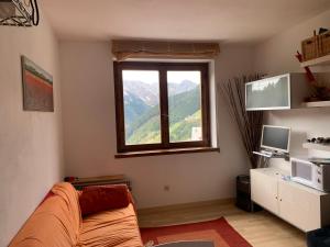 a living room with a couch and a window at Chez Nous in Foppolo