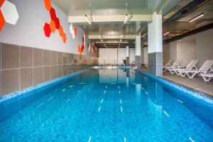 a large swimming pool with chairs in a building at First Joy Hotel in Trabzon