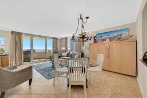 a dining room and living room with a table and chairs at Perdido Sun 214 in Perdido Key