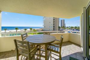 a table and chairs on a balcony with a view of the ocean at Perdido Sun 214 in Perdido Key