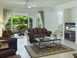 a living room with a couch and a table at The Falls Townhouse 10 by BSL Rentals in Saint James
