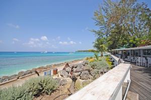 a view of the beach from the deck of a house at The Falls Townhouse 10 by Bluescape in Saint James