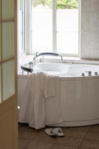a bath tub with a towel draped over it in a bathroom at Villa Hasselbacken in Simrishamn