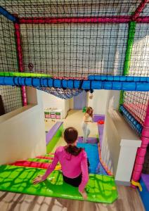 two girls playing in an indoor play gym at Loen Apartments in Loen