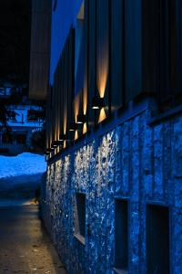 a building with lights on the side of it at night at Luxury Apartments Anja in Jahorina