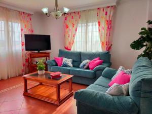 - un salon avec deux canapés bleus et une table basse dans l'établissement Villa Azahar Anita, à Nerja
