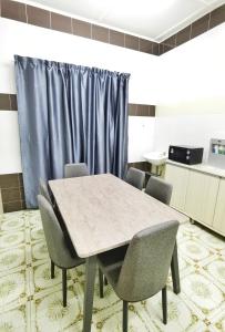 a conference room with a table and chairs at Happy vacation homestay mersing in Mersing +12 photos