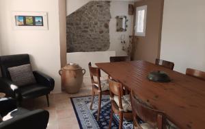 a dining room with a wooden table and chairs at Gite de Barbusse in Tornac