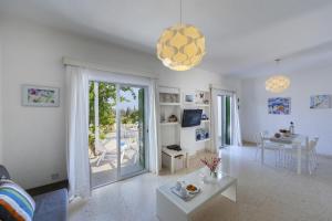 a living room with a couch and a table at Melis Villa - Charming villa in Central Protaras in Protaras