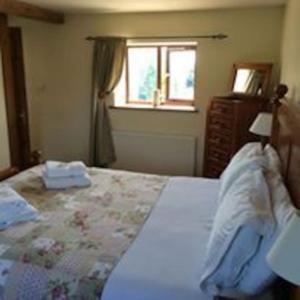 a bedroom with a large bed and a window at Beautiful 4 Bedroom Cottage - Cottage 4 in Doncaster