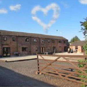 a brick building with a heart in the sky at Beautiful 4 Bedroom Cottage - Cottage 4 in Doncaster