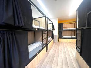 A bed or beds in a room at Onefam Budapest