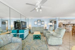 a living room with furniture and a ceiling fan at SeaSpray West 603- Gulf Front in Perdido Key