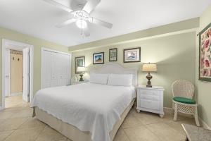 a bedroom with a white bed and a ceiling fan at SeaSpray West 603- Gulf Front in Perdido Key +33 photos