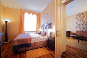 a hotel room with a bed and a window at SKARITZ Hotel & Residence in Bratislava