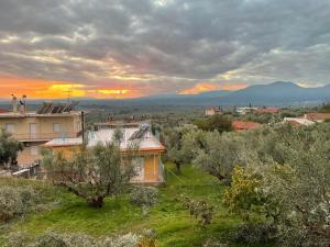 a house in a field with a sunset in the background at Two-floor fully equipped maisonette in the nature 