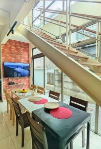a dining room with a table with chairs and stairs at 18 Home team family Gathering first choice in Skudai