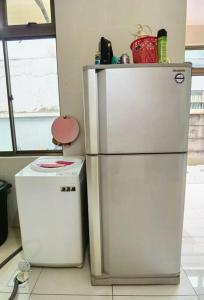 a kitchen with a refrigerator and a small stove at 18 Home team family Gathering first choice in Skudai