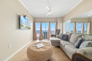 a living room with a couch and a table at Tidewater 609 in Orange Beach