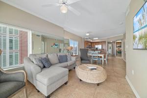 a living room with a couch and a table at Tidewater 609 in Orange Beach