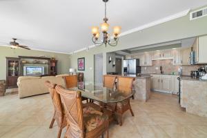 a dining room and kitchen with a table and chairs at SeaSpray West 105- Gulf Front in Perdido Key